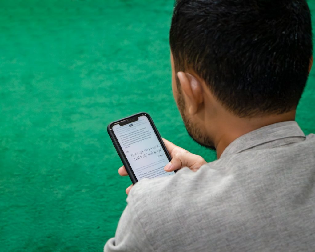 a man holding a cell phone in his hand